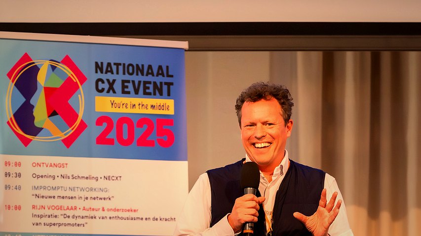 Otto leading a workshop on stage, audience engaged